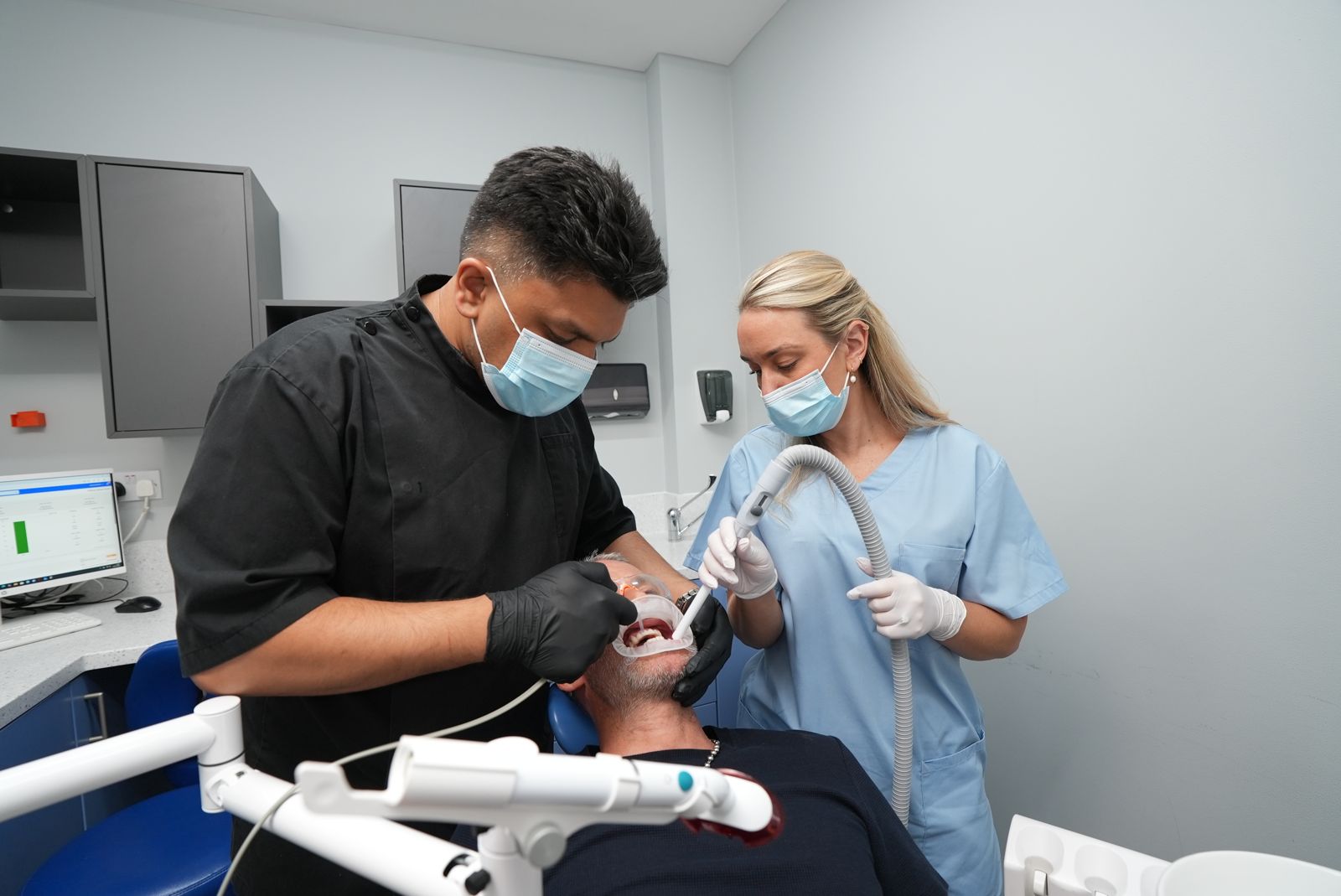 Dentist and dental nurse treating a patient